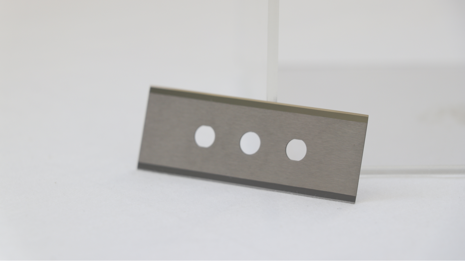 A chipped ceramic blade next to an intact one, highlighting the risk of brittleness