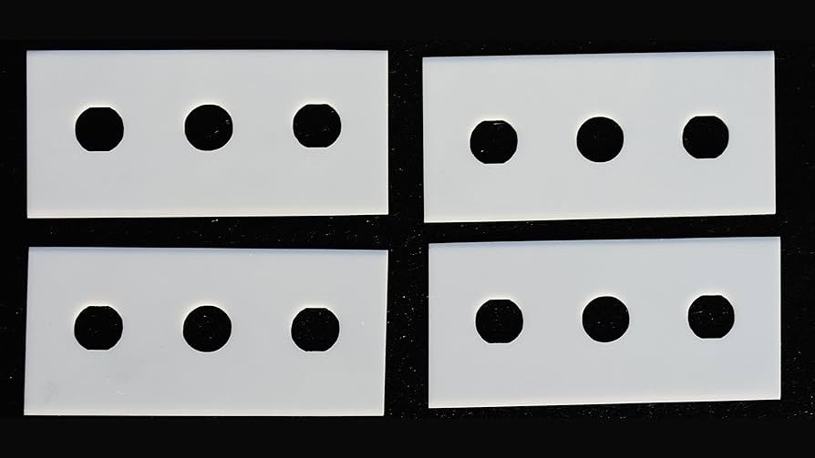 A close-up of a ceramic three-hole blade cutting cleanly through a thin film