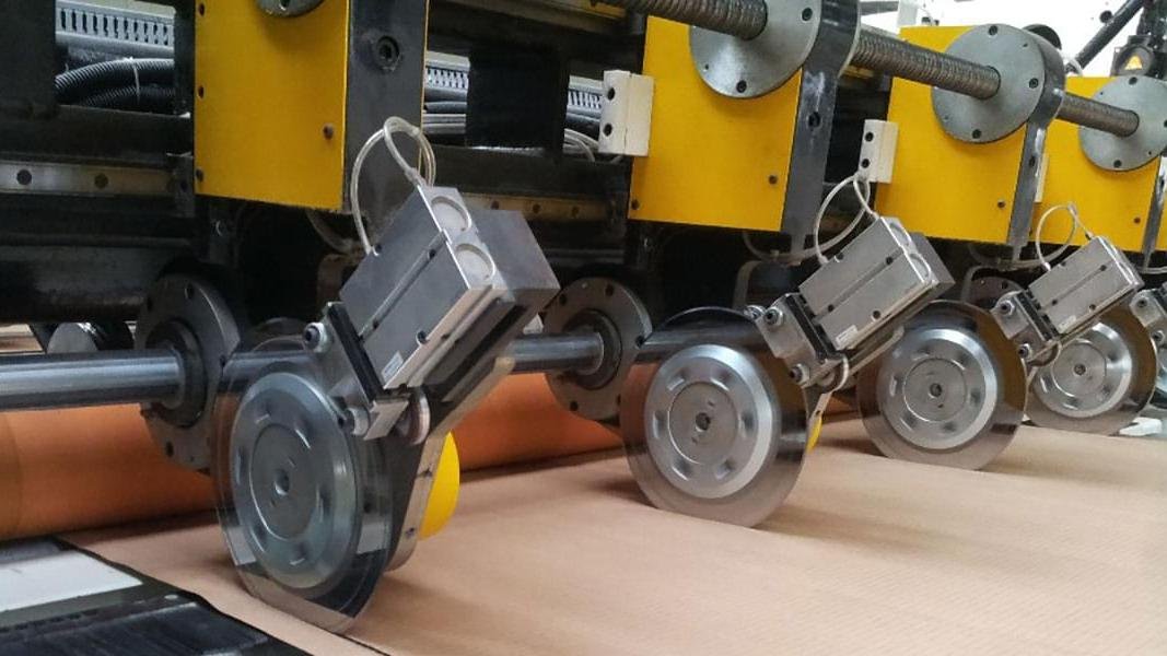 A close-up view of a misaligned industrial blade causing poor cuts