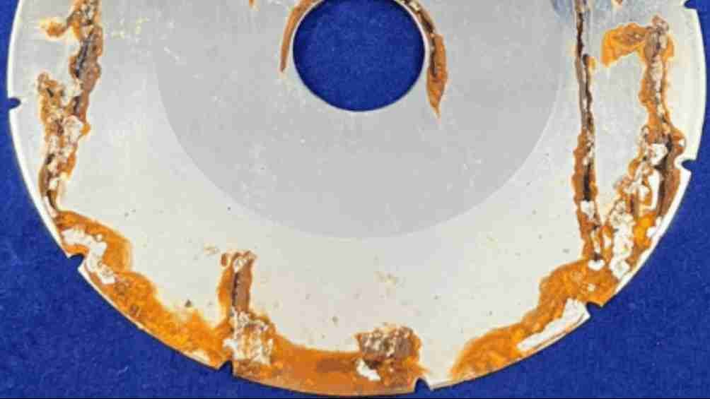 A rusted blade next to a pristine stainless steel blade