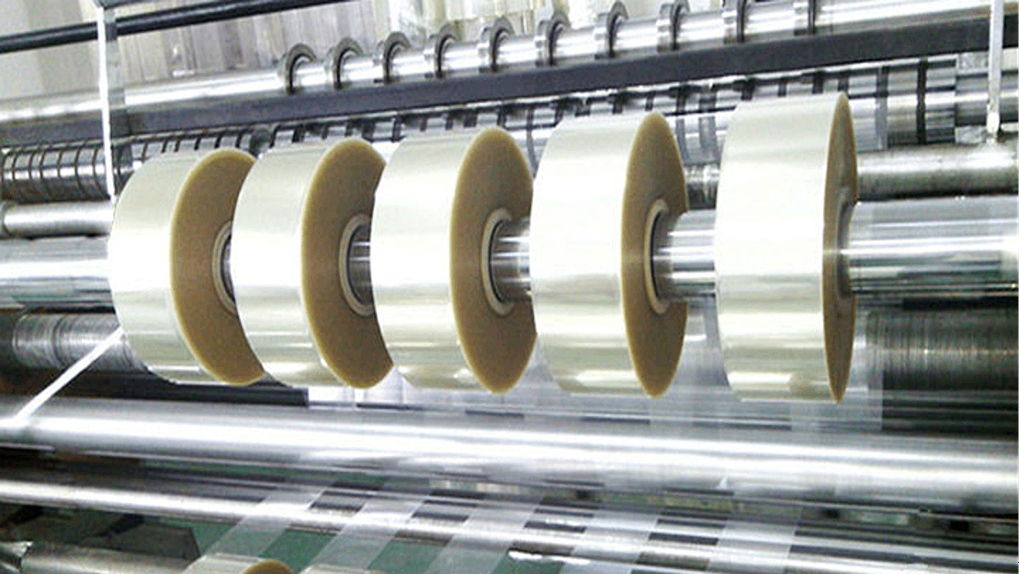 A slitting blade cutting through a roll of PP/PE film