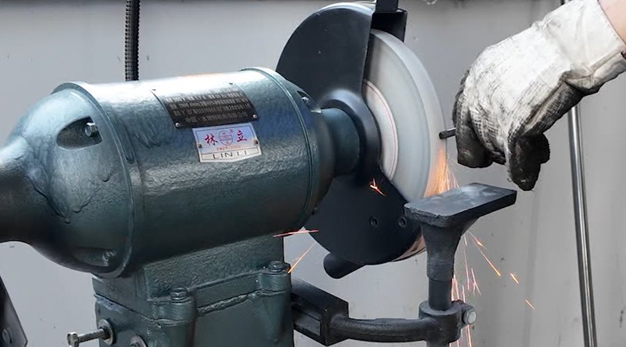 A specialized diamond grinding wheel sharpening a blade