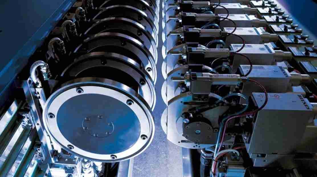 A technician safely installing an industrial blade with proper PPE and tools