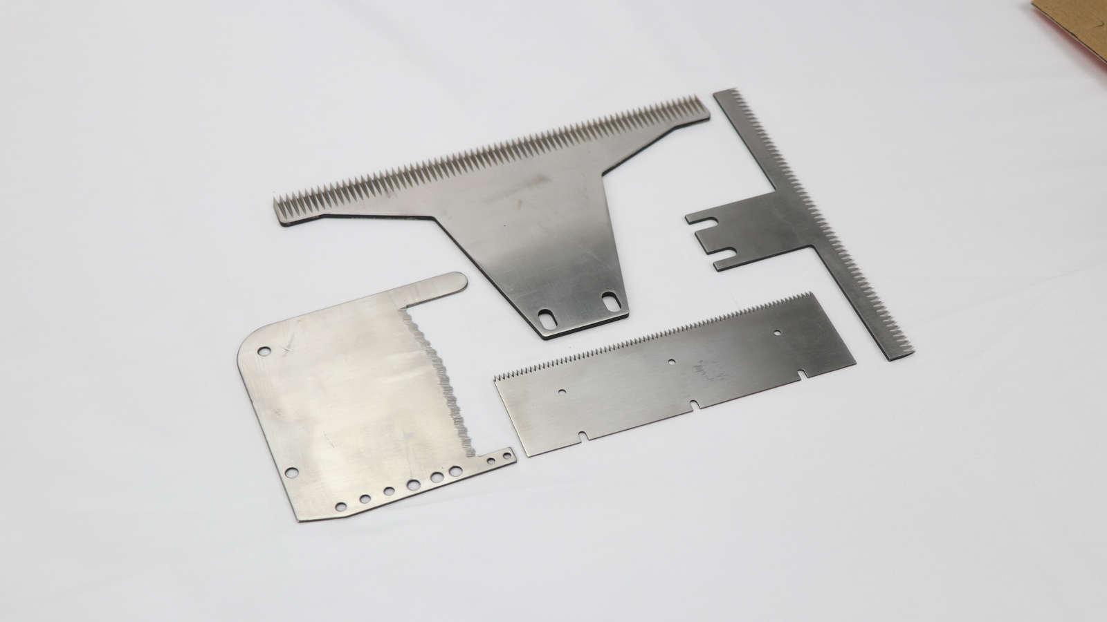 An assortment of perforating blades made from different metals
