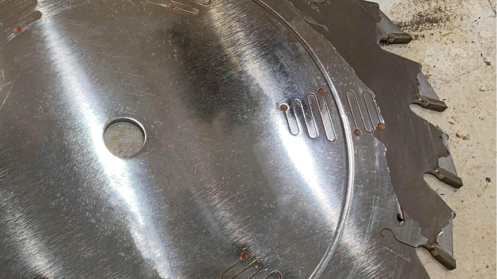 Close-up image of a blade coating flaking and peeling off the surface