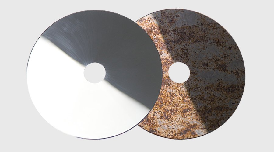 Close-up of a corroded and pitted blade edge after cutting abrasive material