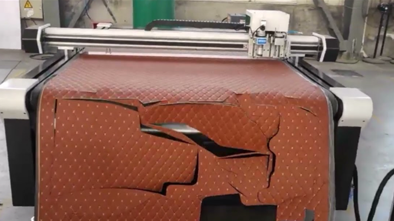 Close-up of a neatly cut leather pattern using a CNC oscillating knife.