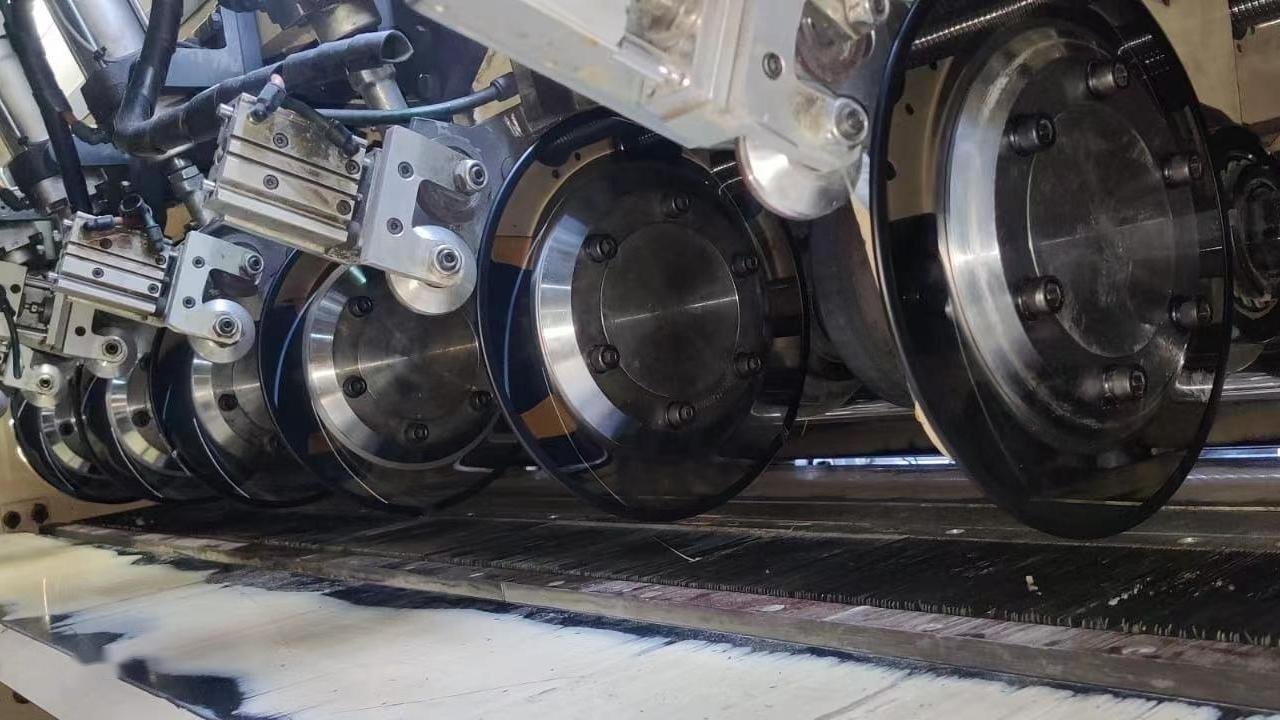 A close-up of a rotary cutting blade in action