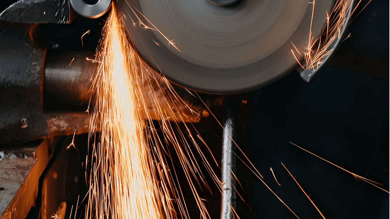 A PCBN-tipped blade making a finishing cut on a hardened steel component, with sparks flying.