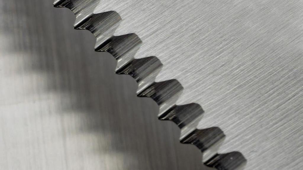 A close-up of a micro-honed industrial blade edge showing its pristine finish.
