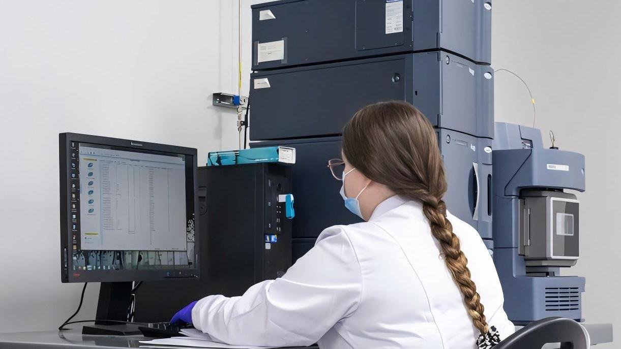 A materials scientist analyzing a blade's microstructure on a computer screen