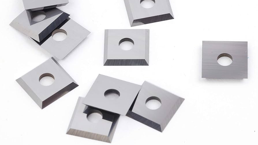 Tungsten carbide saw blade cutting through a piece of wood