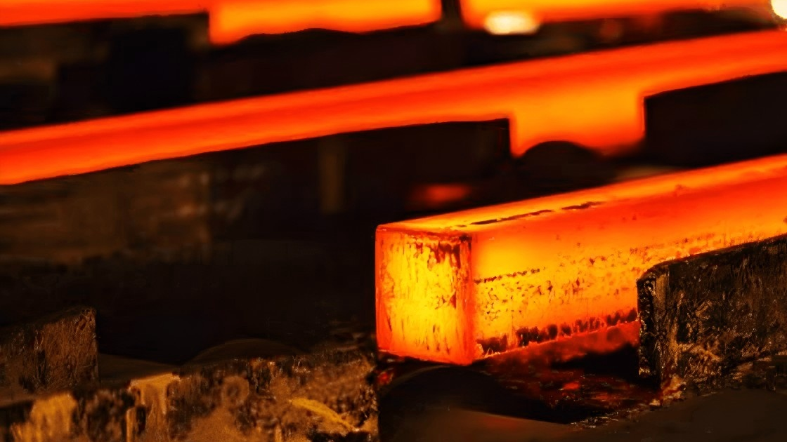 An industrial blade glowing red hot inside a vacuum furnace