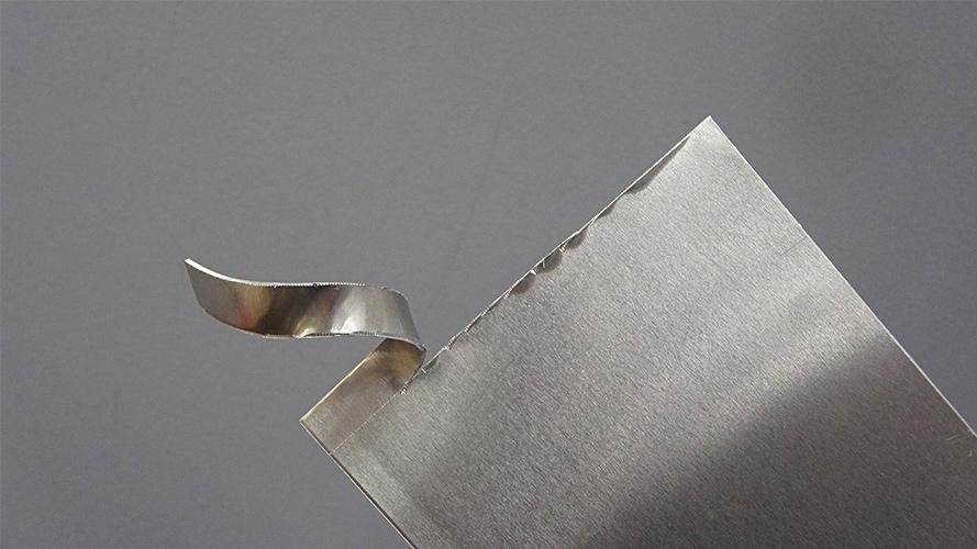 A CNC machine precisely grinding a complex custom blade profile.