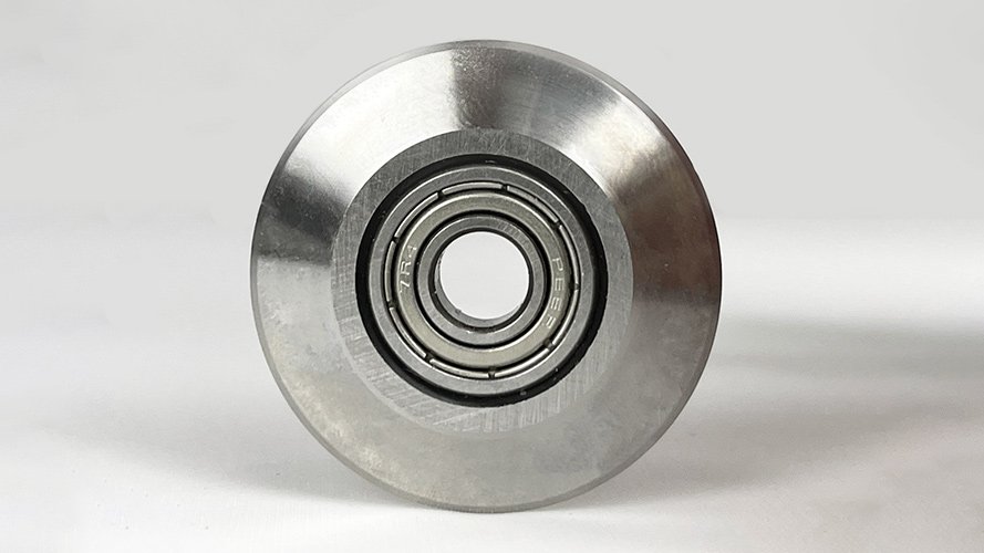 An example of a worn-out industrial bearing next to a new one