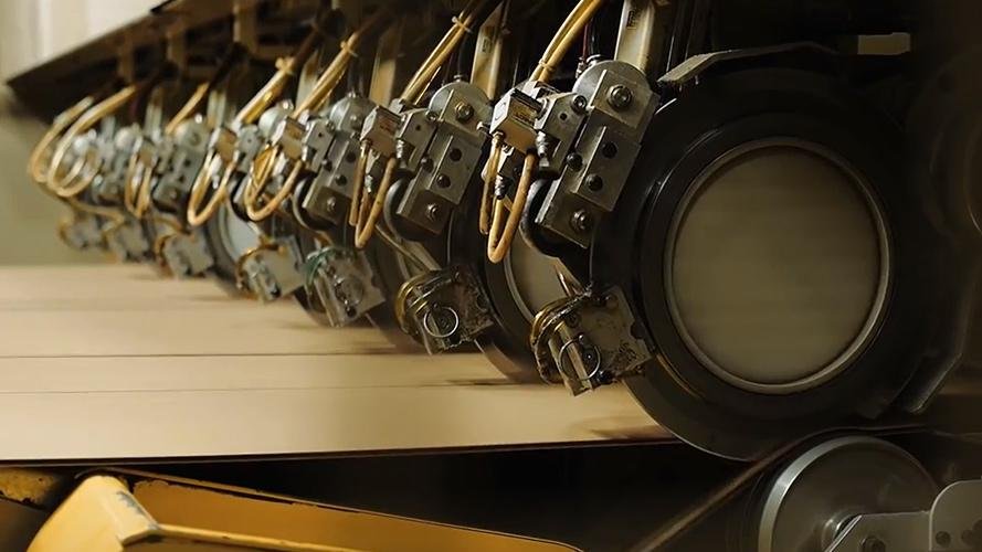 A close-up of a BHS shear blade cutting corrugated board