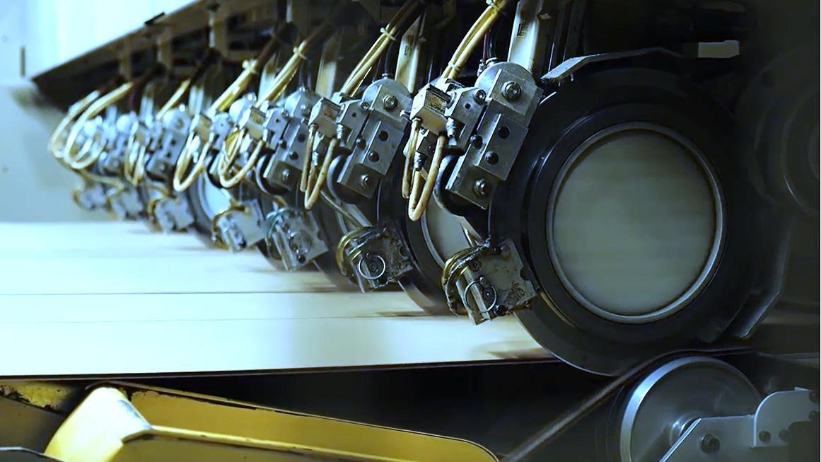 An industrial blade cutting through a thick material cleanly