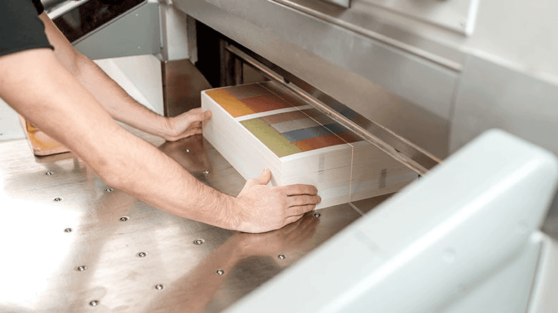 A coated carbide slitting knife in a printing press.