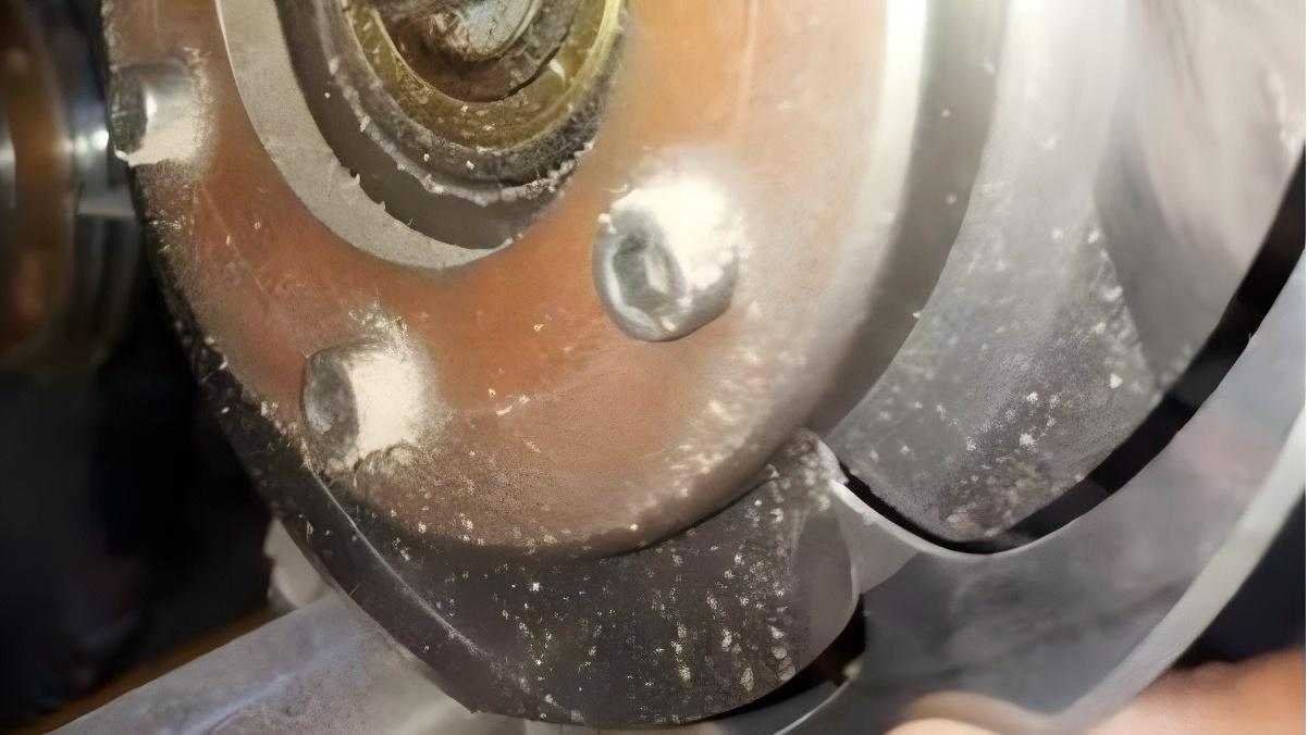 A close-up of a carbide industrial blade showing a chipped edge