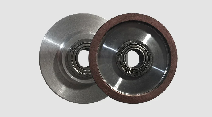 Different types and shapes of grinding wheels on a shelf