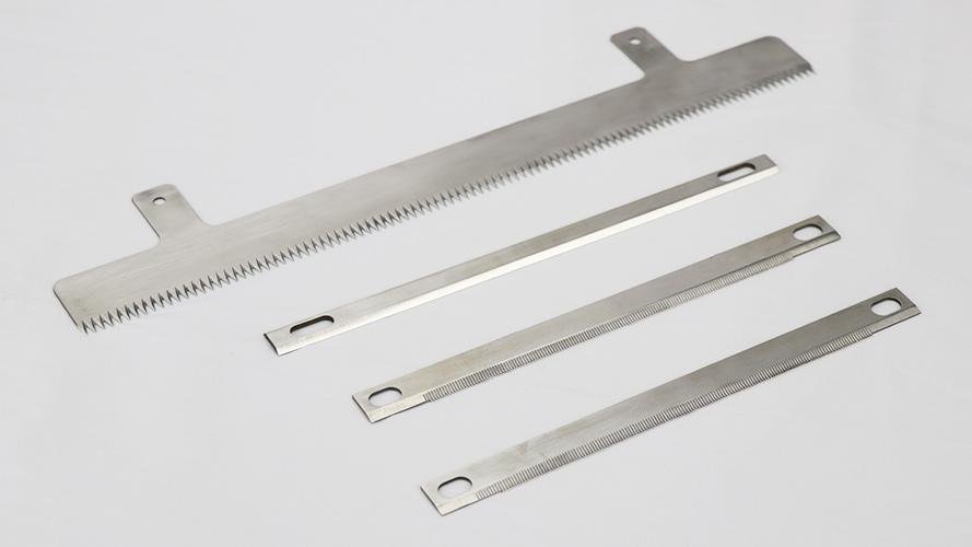 A damaged stainless steel blade with a chipped and dulled edge.