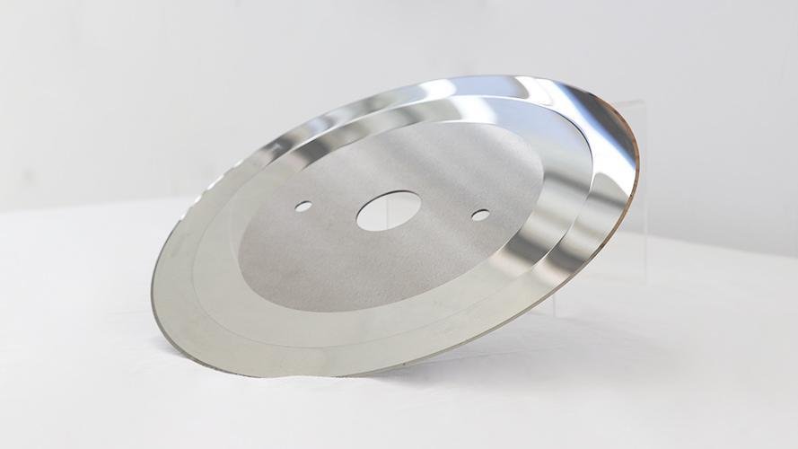 Close-up of a mirror-polished blade surface reflecting light