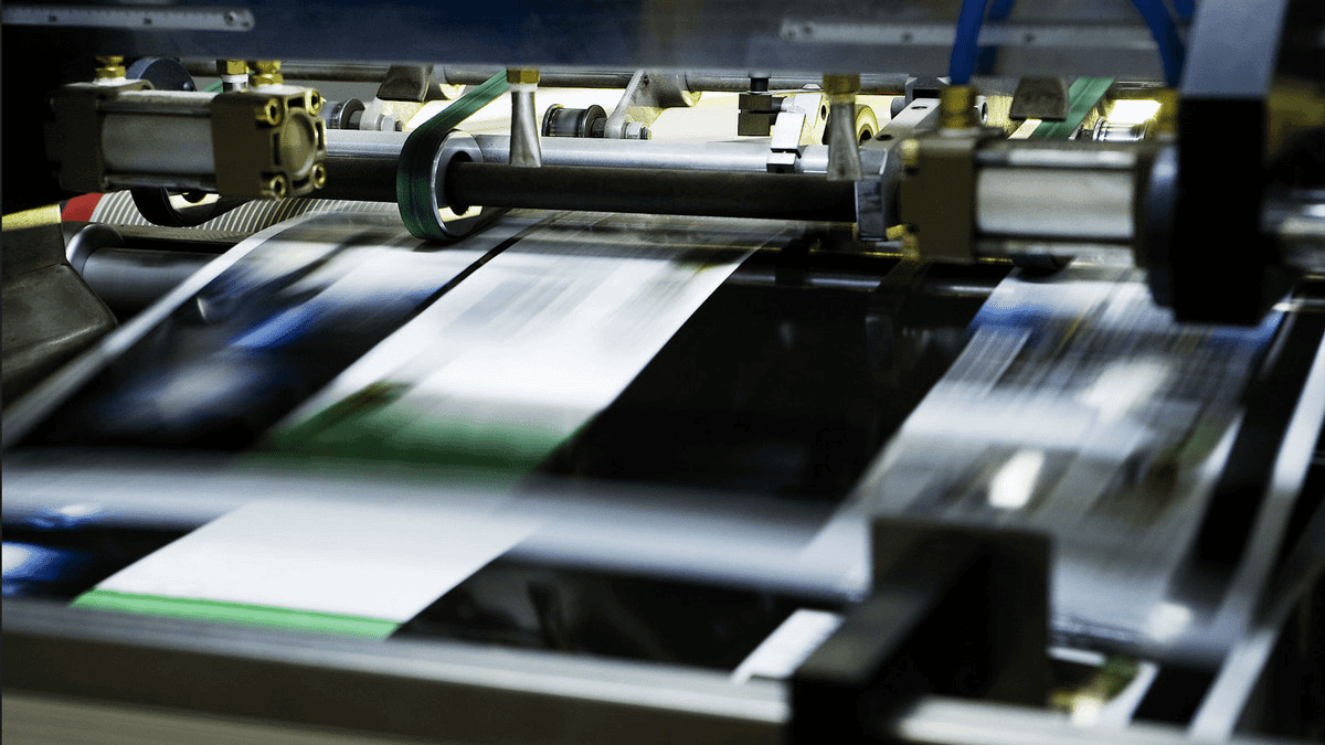 A machine slitting rolls of plastic film with precision blades