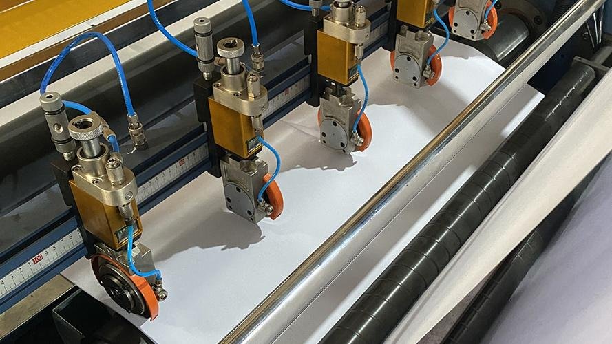 A slitter blade operating at high speed in a paper mill