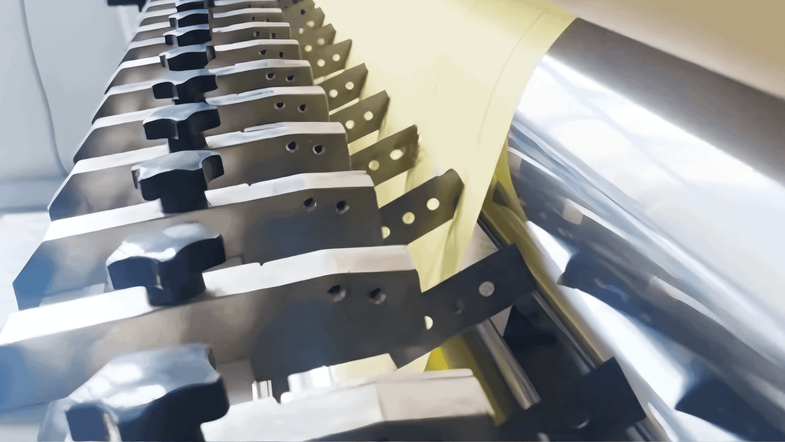 A close-up of multiple industrial blades mounted on a cutter body