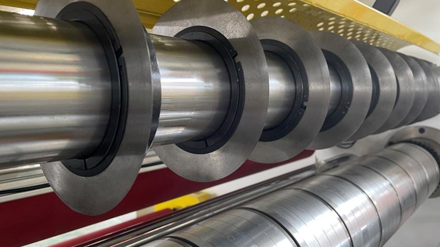 A cleanroom environment showing a machine cutting electronic components.