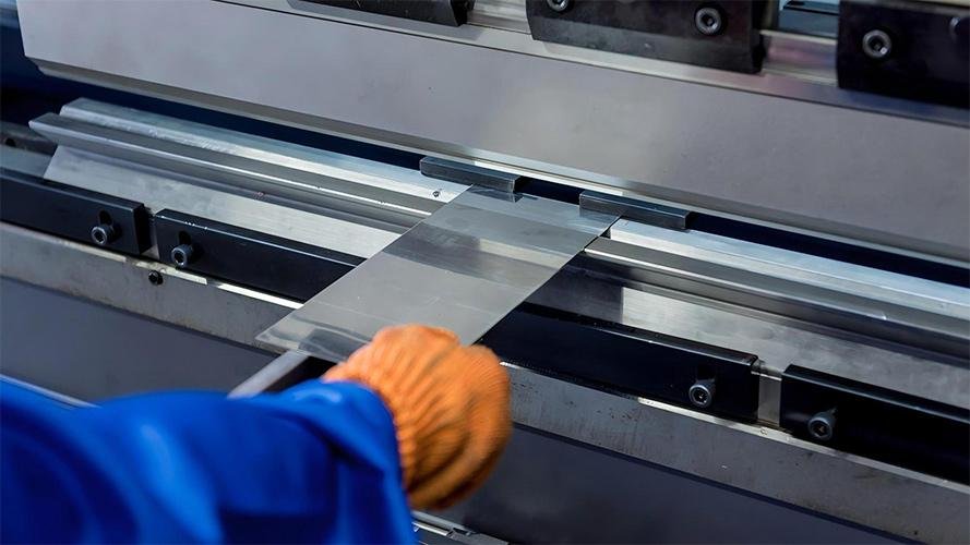 A close-up of a shear blade cutting through thick metal scrap.