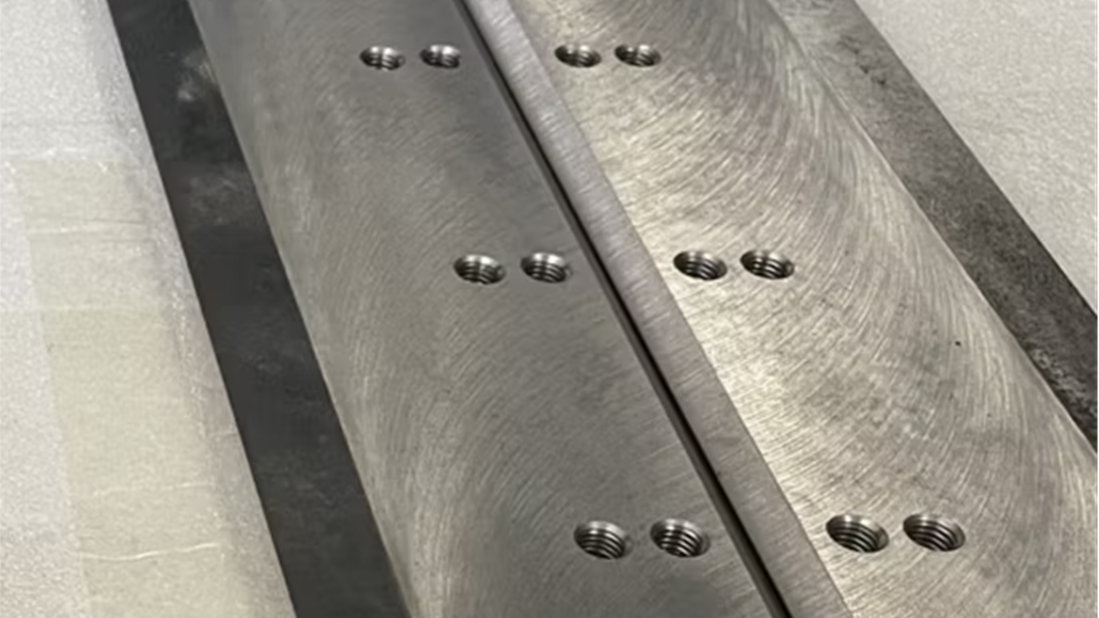 A cracked industrial blade near a mounting hole