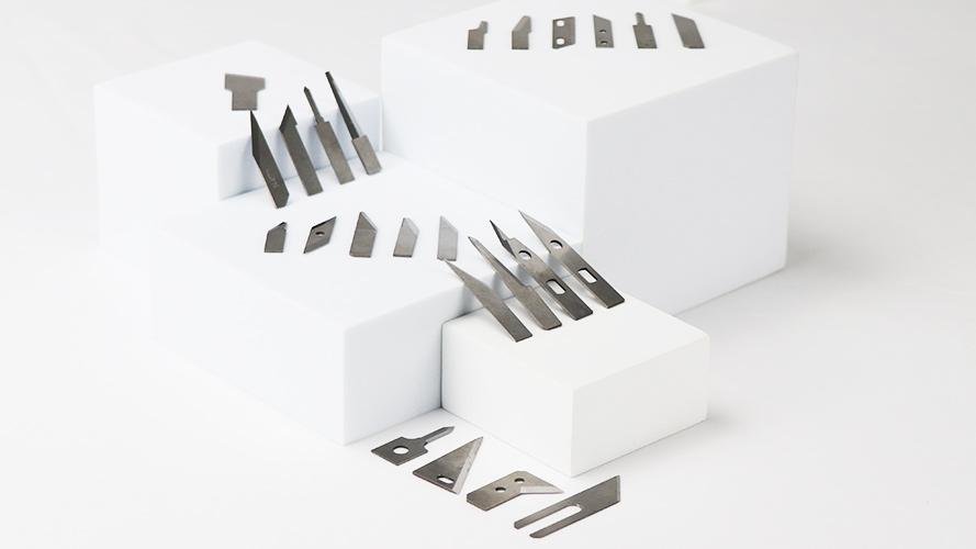 A close-up of a tungsten carbide blade with a magnet nearby.