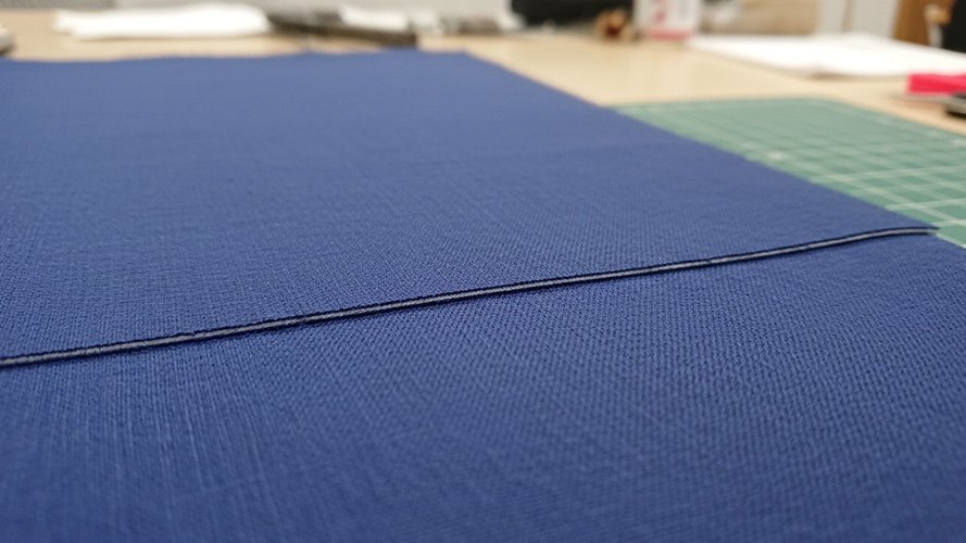 A perfectly clean cut edge on a roll of delicate fabric achieve with a honed blade.