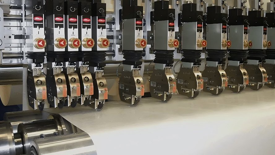 A high-speed paper slitting machine operating efficiently with cool, low-friction blades.