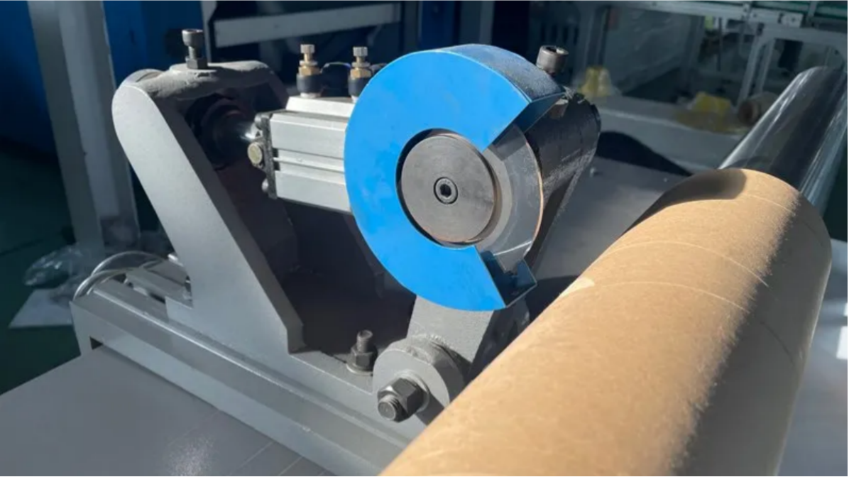 A slitter blade cutting a cardboard tube cleanly