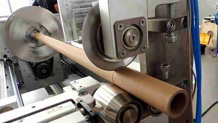 Machine operator adjusting settings for a slitter